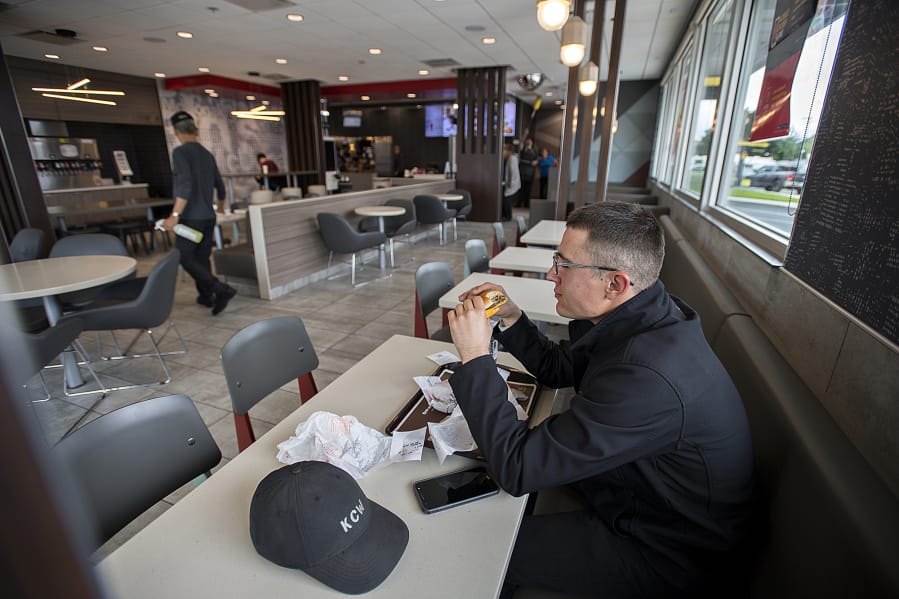 Vancouver resident Daniel O’Connell relaxes in a booth on his lunch break at the McDonald’s at 2814 N.E. Andresen Road in Vancouver, which is one of several local restaurants that has been upgraded to provide casual relaxation for diners.