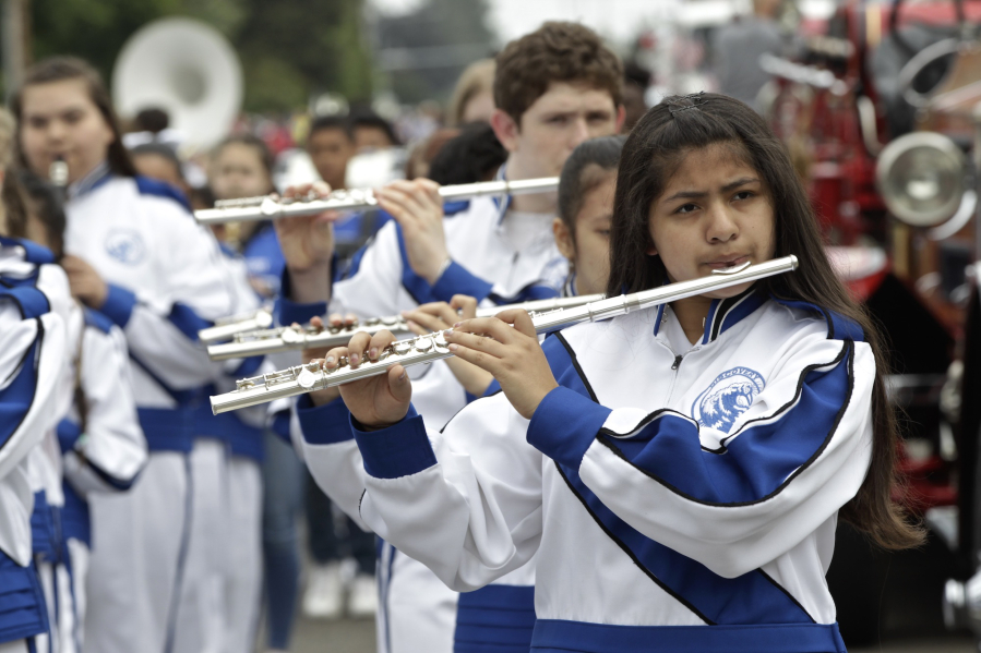 Daisy Iturbide, a seventh-grader at Discovery Middle School, plays in the Discovery Middle School band during the parade on Saturday. It’s the second year the flutist has marched in the annual parade. “It’s my favorite part of the year,” she said.