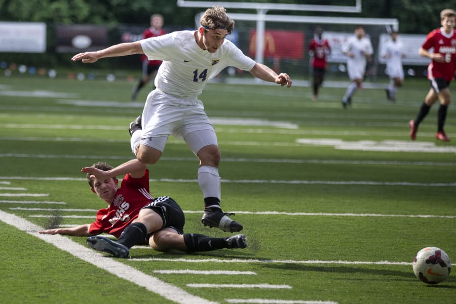 Columbia River Chieftans Jake Connop (14) leaps over an Archbishop Murphy player in the first half of the quarterfinals of Class 2A state high school soccer playoffs on May 19, 2017 at Kiggins Bowl in Vancouver. (Randy L.