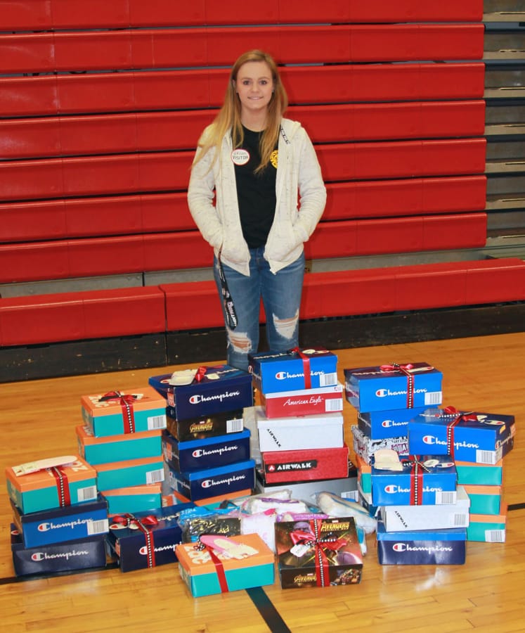 Washougal: Washougal High School senior Hannah Raynor with some of the shoes she collected for her senior project, in which she purchased sneakers and socks for students at Hathaway Elementary School.