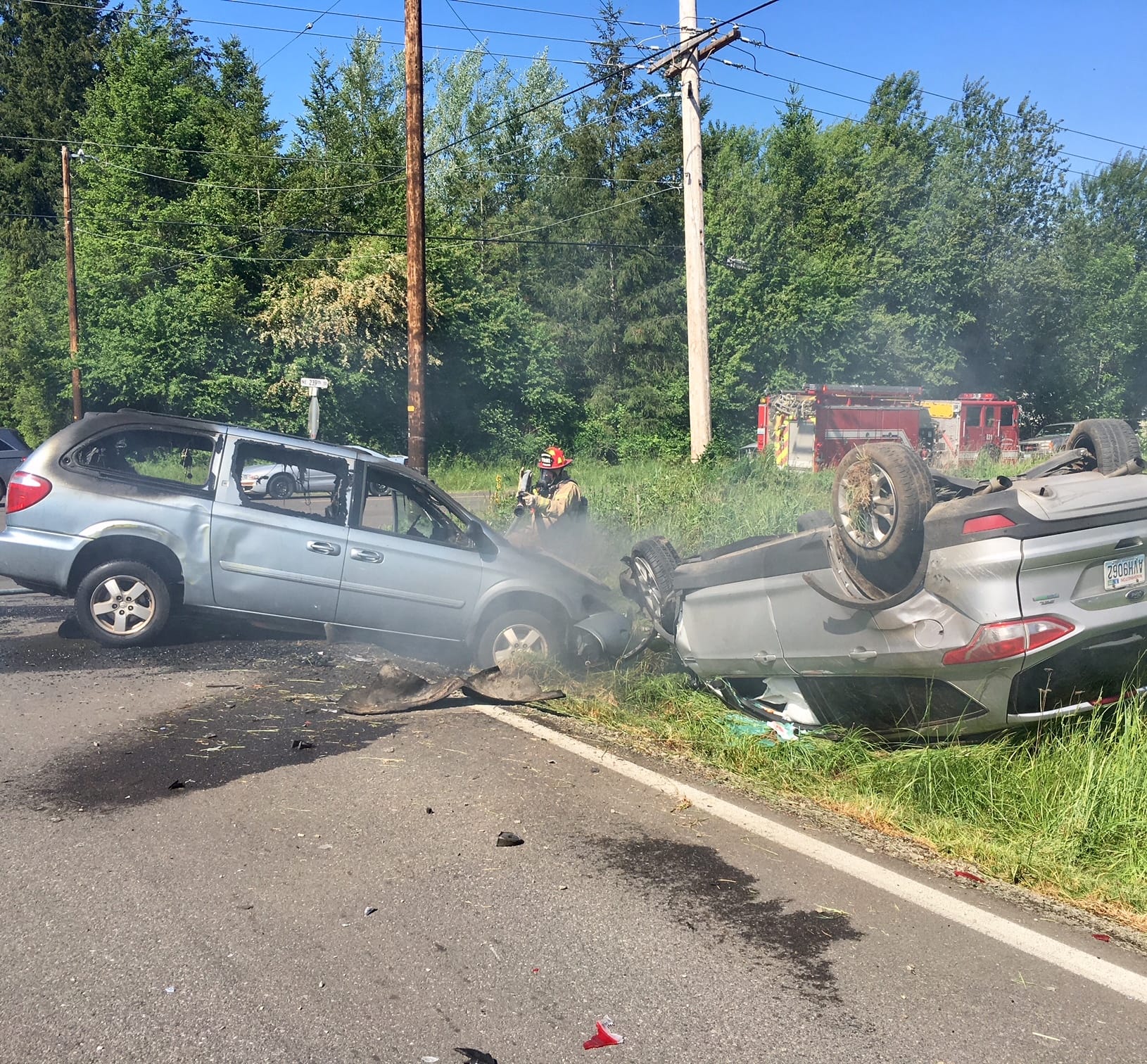Firefighters respond following a two-vehicle collision west of Battle Ground Monday afternoon. Two people were hurt in the crash, and the Clark County Sheriff's Office was investigating what happened.