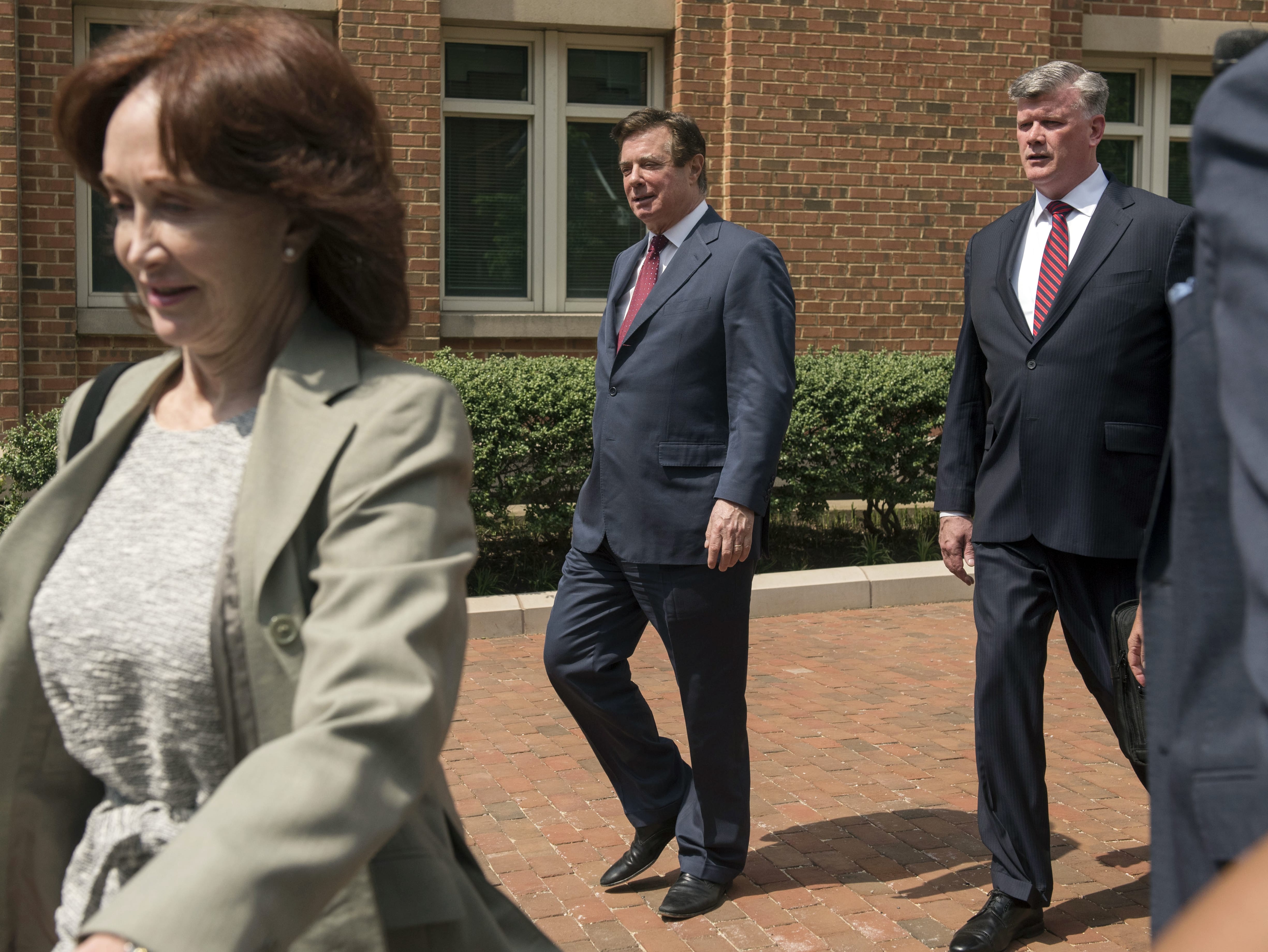 Paul Manafort leaves the Alexandria Federal Courthouse with his wife, Kathleen Manafort, left, and attorney Kevin Downing, right, on Friday, May 4, 2018, in Alexandria, Va.
