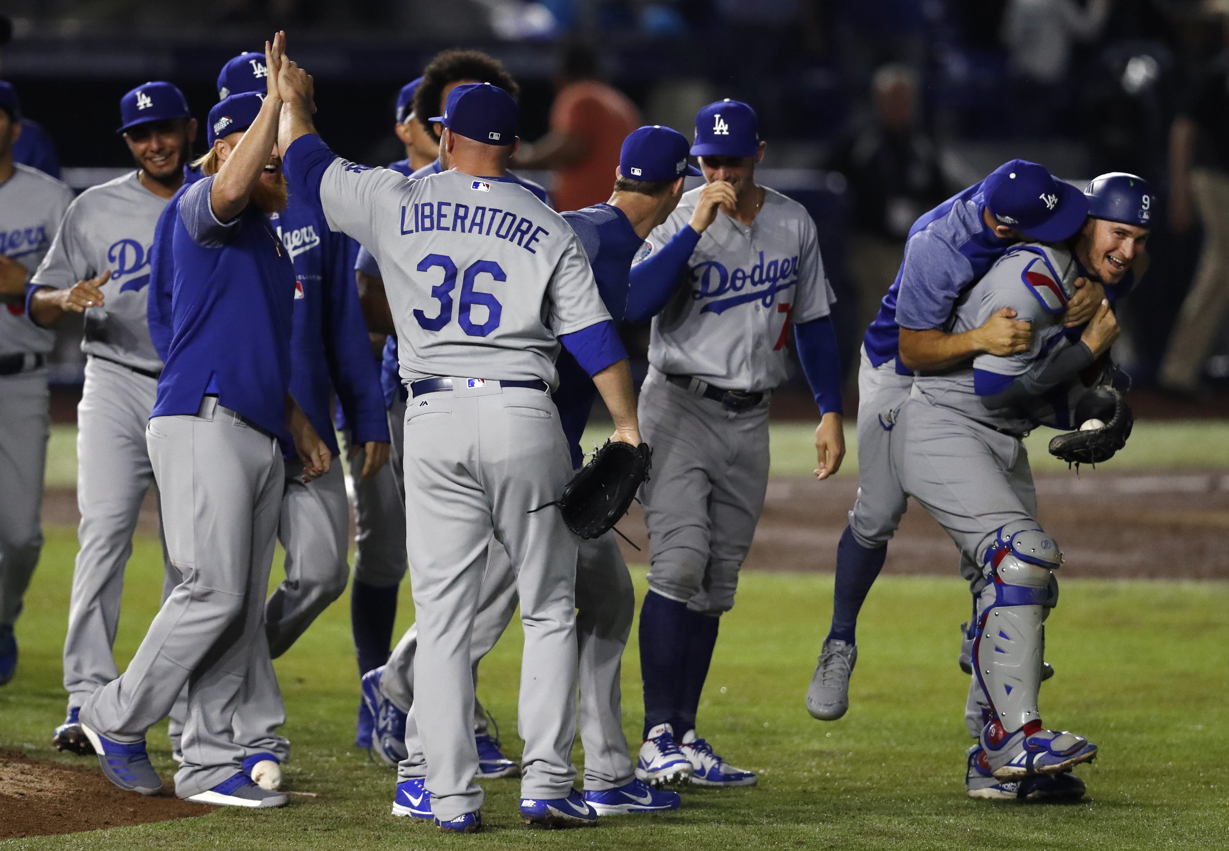 Los Angeles Dodgers catcher Yasmani Grandal, right, and relief pitcher Adam Liberatore (36) celebrate with teammates after the team's 4-0 win over the San Diego Padres in a baseball game in Monterrey, Mexico, Friday, May 4, 2018. Rookie Walker Buehler and a trio of Los Angeles relievers combined for the franchise's 23rd no-hitter in a 4-0 victory in the opener of a neutral-site series.