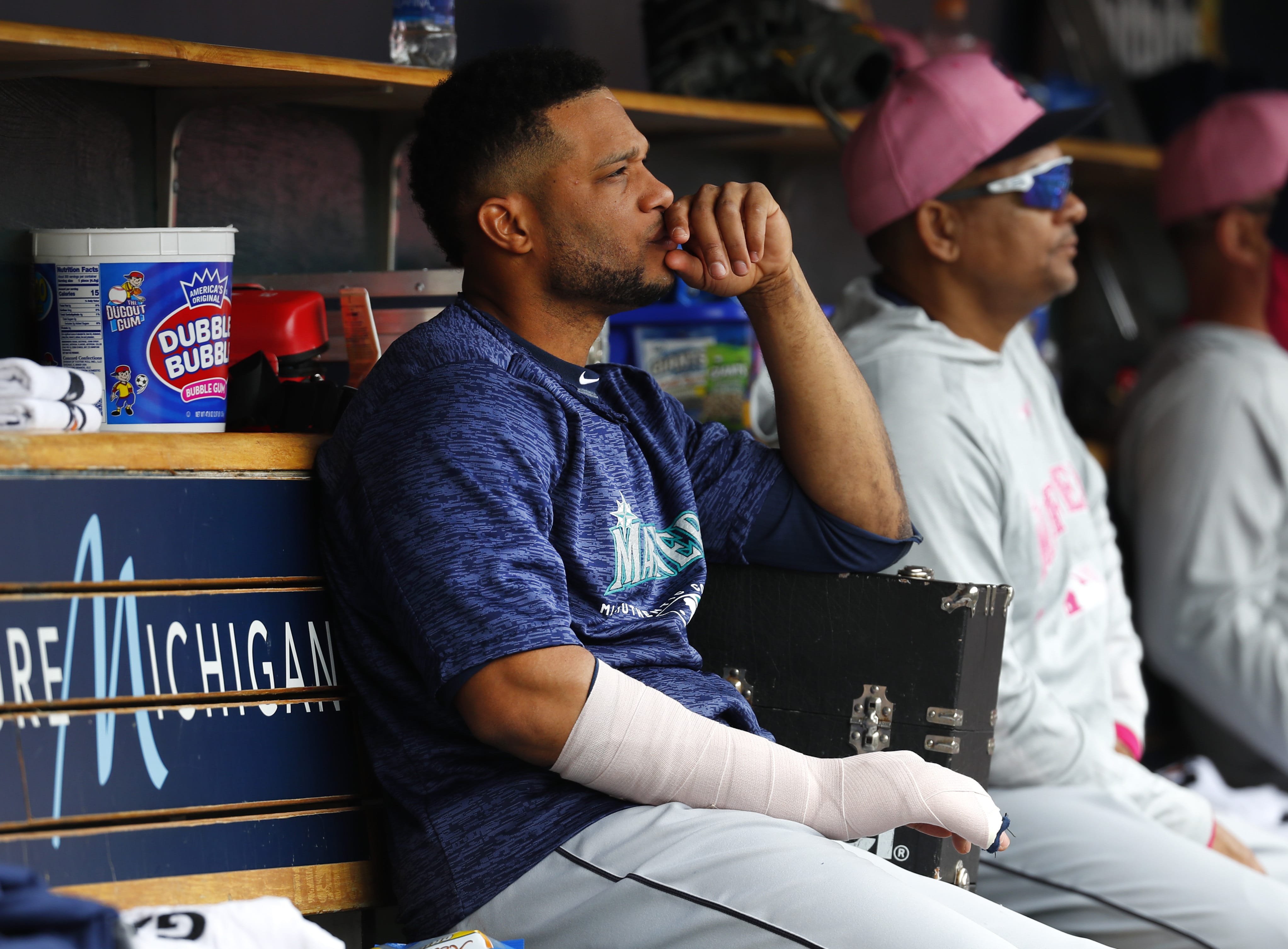 Seattle Mariners' Robinson Cano sits on the bench with his hand wrapped in the fifth inning of a baseball game against the Detroit Tigers in Detroit, Sunday, May 13, 2018.