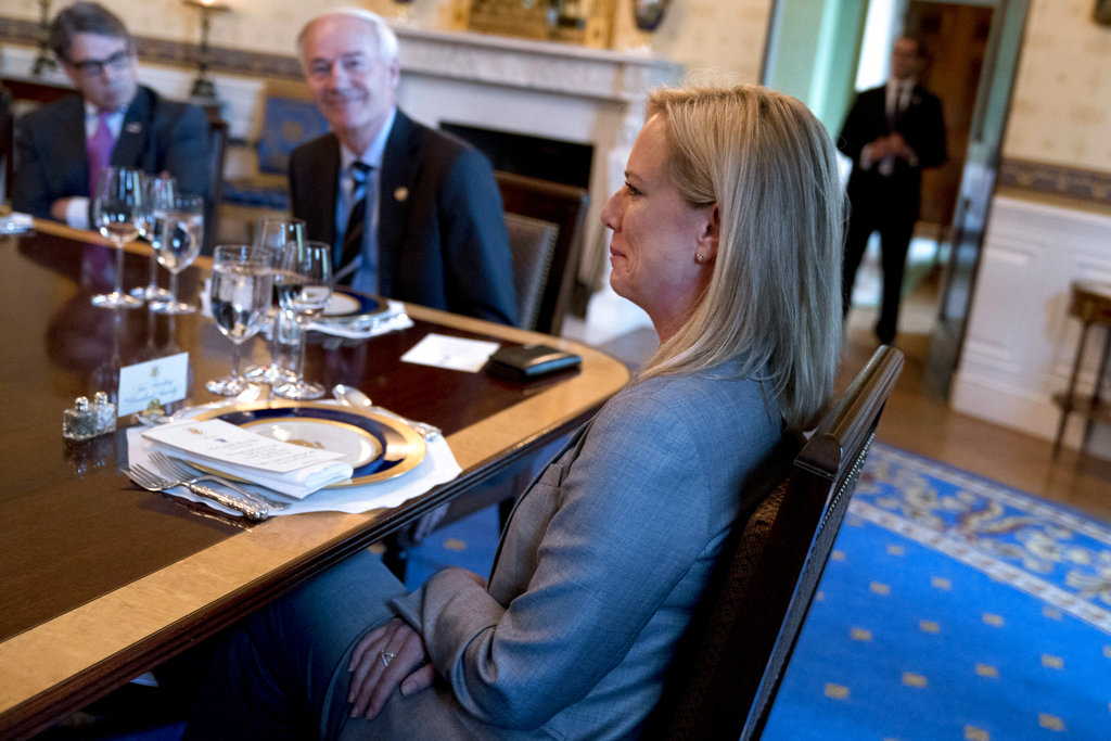 From left, Energy Secretary Rick Perry, Arkansas Gov. Asa Hutchinson, and Homeland Security Secretary Kirstjen Nielsen, attend a meeting with President Donald Trump and a group of governors in the Blue Room of the White House in Washington, Monday, May 21, 2018, to discuss border security and restoring safe communities.