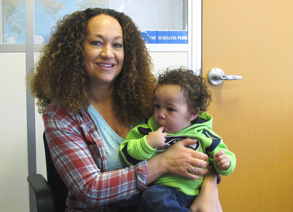 FILE - In this March 20, 2017, file photo, Rachel Dolezal poses for a photo with her son, Langston, at the bureau of The Associated Press in Spokane, Wash. Dolezal, a former NAACP leader in Washington state whose life unraveled after she was outed as a white woman pretending to be black, has been charged with welfare fraud, news station KHQ-TV reports Thursday, May 24, 2018. (AP Photo/Nicholas K.