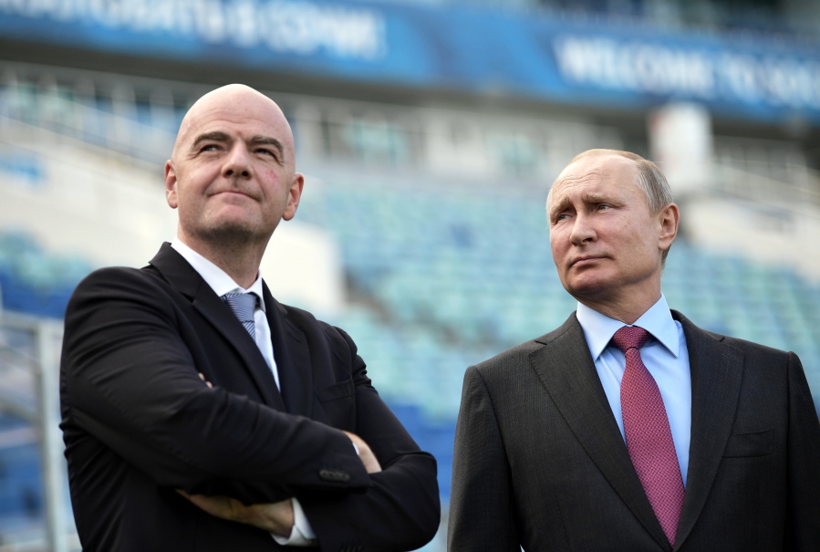 Russian President Vladimir Putin, right, and FIFA president Gianni Infantino visit the Fisht Stadium in the Black Sea resort of Sochi, Russia, on Thursday. Putin says he wants to see “strong-willed, no-compromise” football from Russia’s team at the upcoming World Cup.