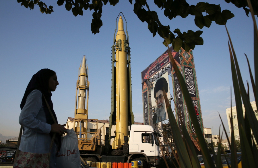 A Ghadr-H missile, center, a solid-fuel surface-to-surface Sejjil missile and a portrait of the Supreme Leader Ayatollah Ali Khamenei are displayed at Baharestan Square in Tehran, Iran. Facing a second suspected Israeli strike killing Iranian forces in Syria, the Islamic Republic has few ways to retaliate as its officials wrestle both domestic unrest at home and the prospects of its nuclear deal collapsing abroad.