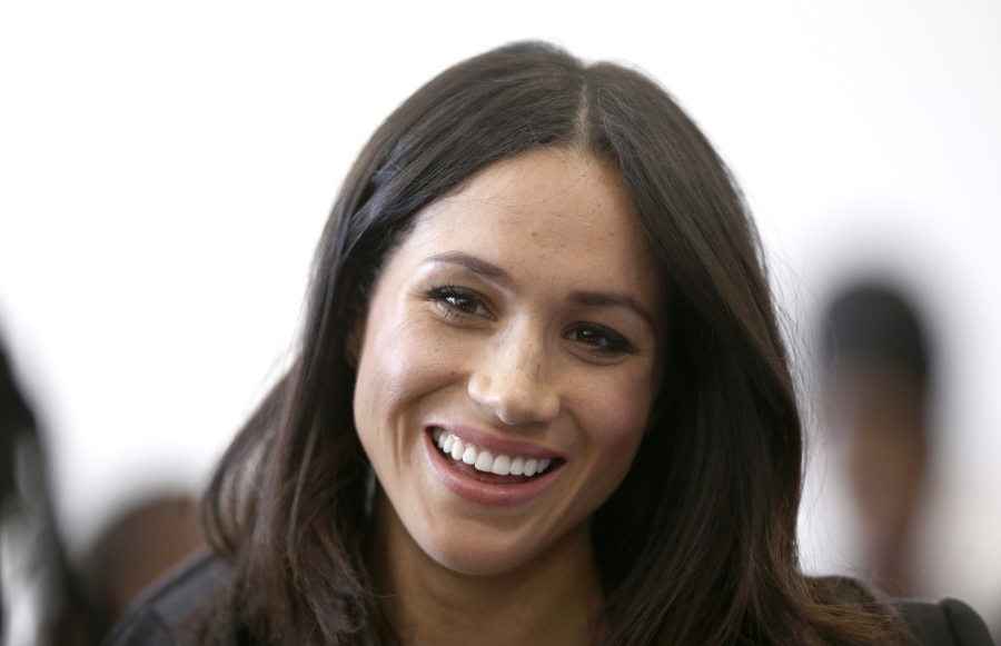 FILE - In this Wednesday April 18, 2018 file photo, Meghan Markle attends a reception with Britain’s Prince Harry for the Commonwealth Youth Forum at the Queen Elizabeth II Conference Centre, London, during the Commonwealth Heads of Government Meeting. Royal officials said Friday May 4, 2018, Meghan Markle’s divorced parents Thomas Markle and Doria Ragland will come to London before her May 19 wedding to Prince Harry and will meet with Queen Elizabeth II and other royals.