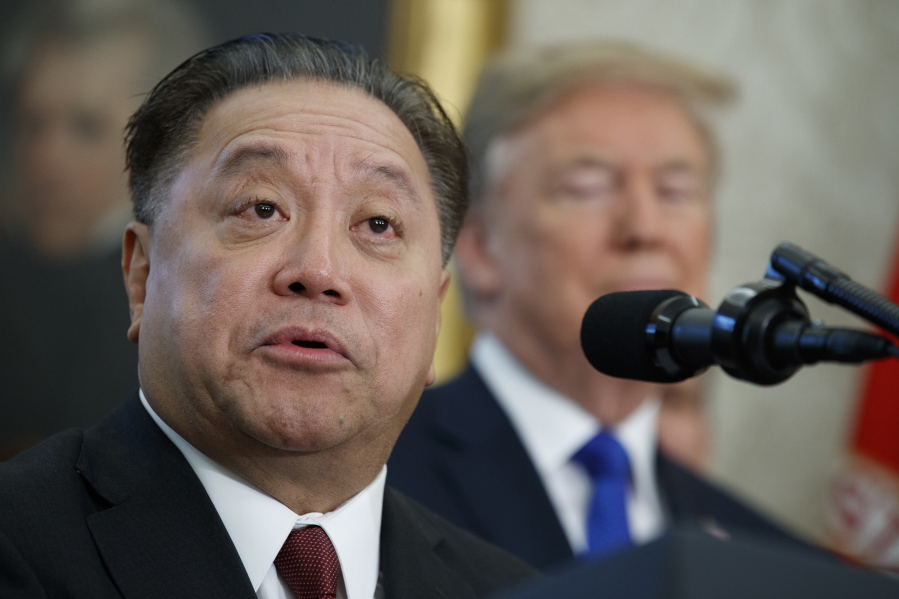 FILE - In this Nov. 2, 2017, file photo, Broadcom CEO Hock Tan speaks as President Donald Trump listens during an event to announce the company is moving its global headquarters to the United States, in the Oval Office of the White House, in Washington. The highest-paid CEO in Equilar’s analysis was Hock Tan of Broadcom, who made $103.2 million. The vast majority of Tan’s compensation came in the form of a stock grant, valued at $98.3 million.