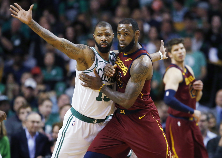 Cleveland Cavaliers forward LeBron James, right, fights for position against Boston Celtics forward Marcus Morris (13) during the third quarter of Game 1 of the NBA basketball Eastern Conference Finals, Sunday, May 13, 2018, in Boston.