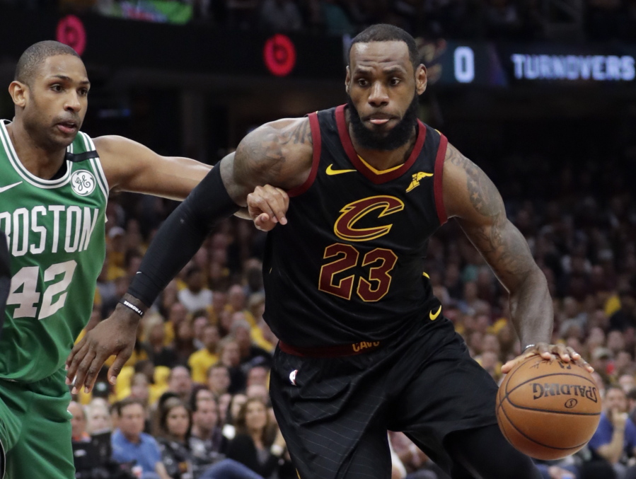 Cleveland Cavaliers’ LeBron James (23) drives past Boston Celtics’ Al Horford (42), from Dominican Republic, in the first half of Game 4 of the NBA basketball Eastern Conference finals, Monday, May 21, 2018, in Cleveland.