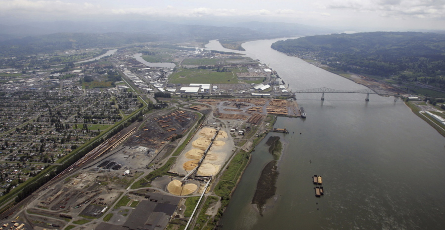 Timber processing facilities line the banks of the Columbia River in Longview near the Lewis and Clark Bridge on May 12, 2005. Six Western states and several national industry groups have lined up against Washington state in a legal battle over its decision to reject permits for a massive proposed coal-export terminal on the Columbia River.
