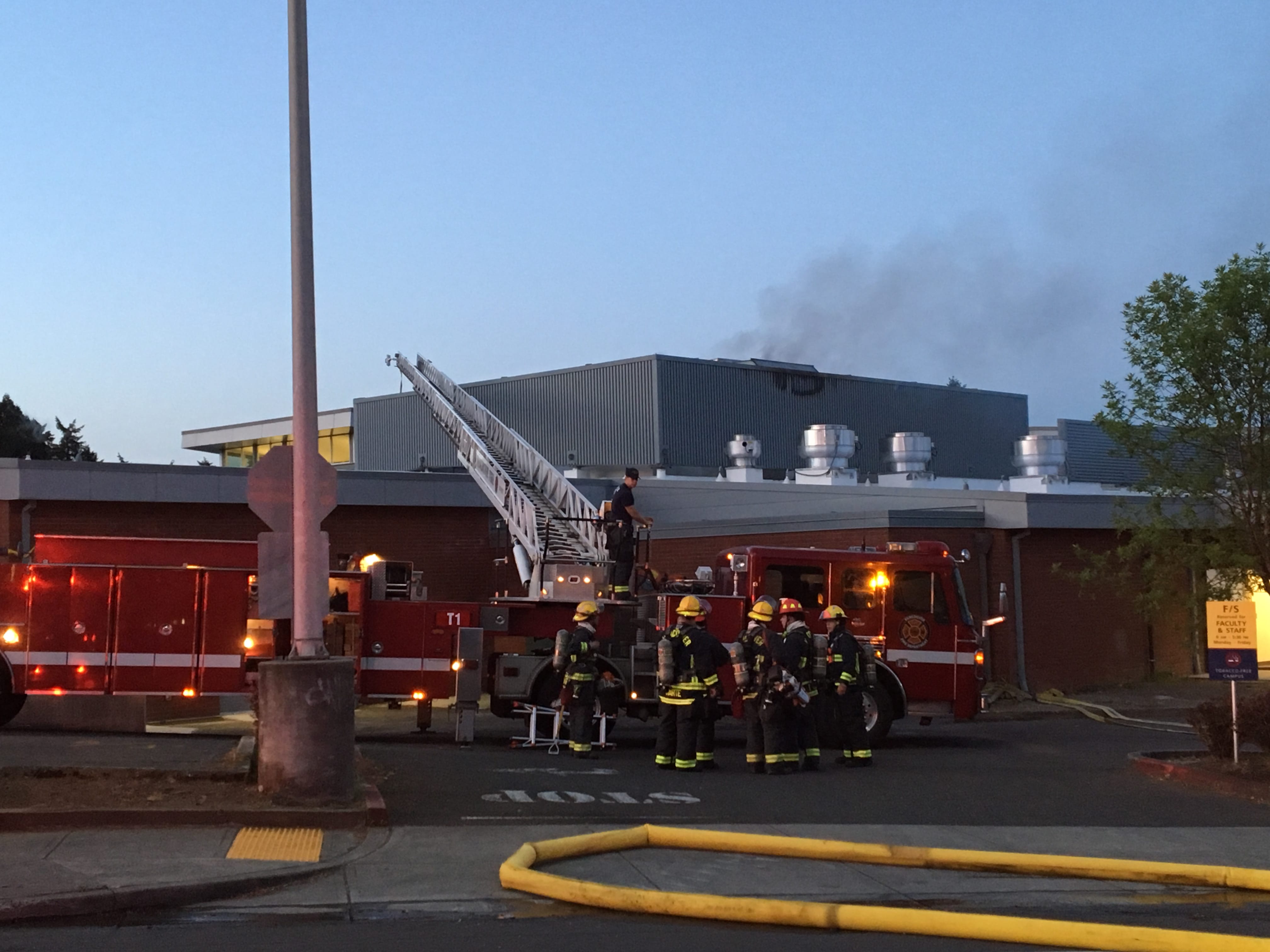 Vancouver firefighters respond to an electrical fire Monday morning on the roof of Clark College's Culinary Institute.