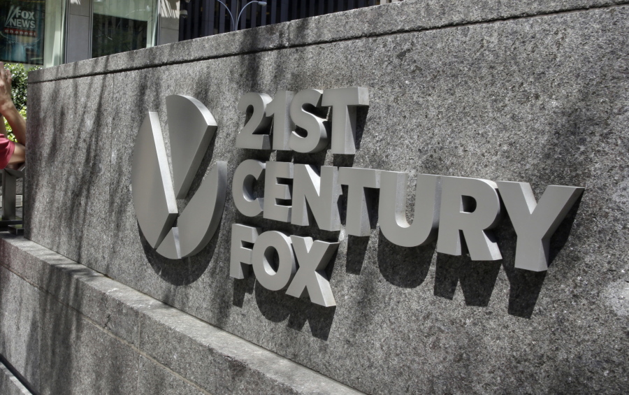 FILE - This Aug. 1, 2017, file photo shows the Twenty-First Century Fox sign outside of the News Corporation headquarters building in New York. Comcast says it’s considering making an offer to buy Twenty-First Century Fox, which would put it in a head-to-head bidding fight with Disney.