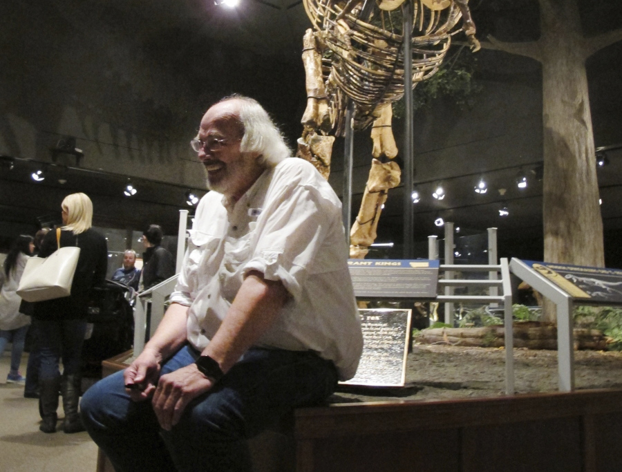 FILE - In this May 21, 2016, file photo, Jack Horner sits under Montana’s T-Rex in the Museum of the Rockies in Bozeman, Mont. The Montana paleontologist, Horner, who consulted with director Steven Spielberg on the “Jurassic Park” movies is developing a three-dimensional hologram exhibit that will showcase the latest theories on what dinosaurs looked like. Horner and entertainment company Base Hologram are aiming to have multiple traveling exhibits ready to launch in spring 2018.