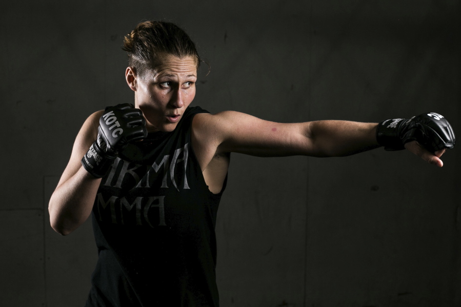 Kelly Clayton poses April 26 in Yakima. Clayton has put a dozen amateur MMA fights behind her and is now embarking on her pro debut. She made a decision to find herself, a journey that led her grappling, kicking and punching opponents in a cage.