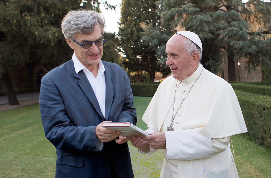 This image released by Focus Features shows Pope Francis, right, with director Wim Wenders during the filming of the documentary “Pope Francis: A Man Of His Word.” (Focus Features via AP)
