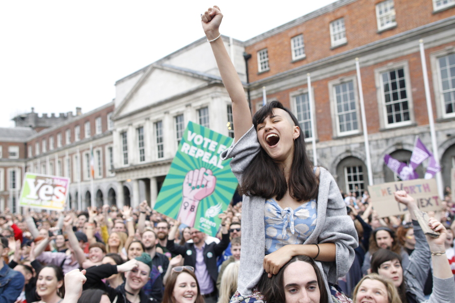A woman from the"Yes" campaign reacts after the final result was announced, after the Irish referendum on the 8th Amendment of the Irish Constitution at Dublin Castle, in Dublin, Ireland, Saturday May 26, 2018. The prime minister of Ireland says the passage of a referendum paving the way for legalized abortions is a historic day for his country and a great act of democracy.