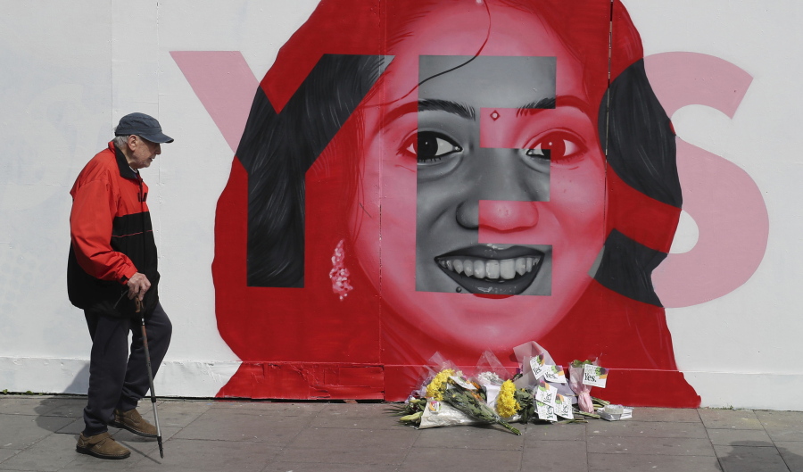 A man walks past a mural showing Savita Halappanavar, a 31-year-old Indian dentist who had sought and been denied an abortion before she died after a miscarriage in a Galway hospital, with the word YES over it, in Dublin, Ireland, on the day of a referendum on the 8th amendment of the constitution. The referendum on whether to repeal the country’s strict anti-abortion law is being seen by anti-abortion activists as a last-ditch stand against what they view as a European norm of abortion-on-demand, while for pro-abortion rights advocates, it is a fundamental moment for declaring an Irish woman’s right to choose.