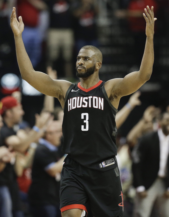 Houston Rockets guard Chris Paul reacts after a 3-pointer by PJ Tucker during the second half in Game 5 of an NBA basketball second-round playoff series against the Utah Jazz, Tuesday, May 8, 2018, in Houston.