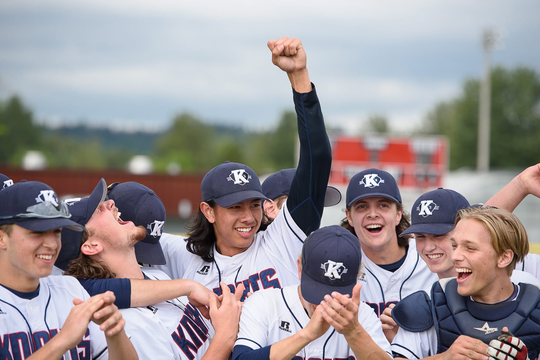 King's Way Christian senior pitcher Sam Lauderdale (center) and teammates celebrate their 4-0 regional final victory over La Center on Saturday, May 19, 2018, at Castle Rock.