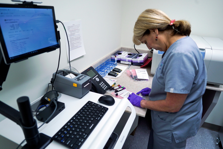Stephanie Richurk, a nurse at the University of Pittsburgh Medical Center, sorts blood samples collected from participants in the “All of Us” research program in Pittsburgh. The National Institutes of Health announced on Tuesday that it will open nationwide enrollment and is seeking 1 million volunteers to share their DNA and medical records.
