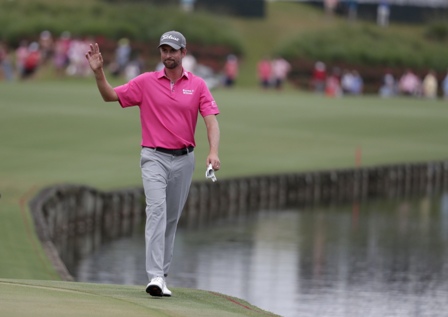 Webb Simpson waves as he walks to the 18th hole during the final round of the Players Championship golf tournament, Sunday, May 13, 2018, in Ponte Vedra Beach, Fla. Simpson won the tournament.