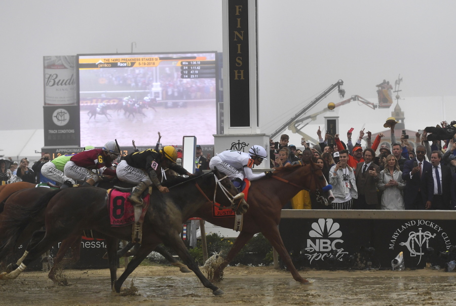 Justify with Mike Smith atop wins the 143rd Preakness Stakes horse race at Pimlico race track, Saturday, May 19, 2018, in Baltimore. Bravazo with Luis Saez aboard wins second with Tenfold with Ricardo Santana Jr. atop places.