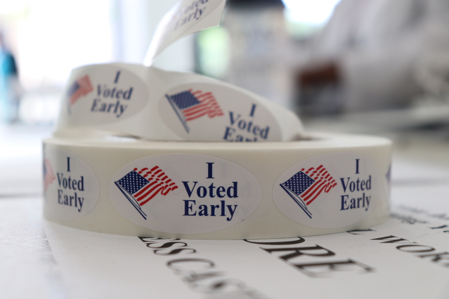A roll of stickers awaiting distribution to early voters sits on a table at the check-in station at the Pulaski County Courthouse Annex in Little Rock, Ark. Voters in four states are casting ballots Tuesday as the 2018 midterm elections take shape. Primaries are set in Arkansas, Georgia and Kentucky while voters in Texas settle several primary runoffs from their first round of voting in March. (AP Photo/Kelly P.