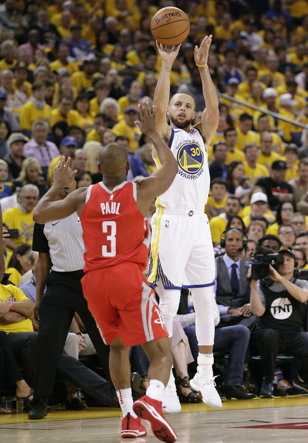 Golden State Warriors guard Stephen Curry (30) shoots against Houston Rockets guard Chris Paul (3) during the second half of Game 3 of the NBA basketball Western Conference Finals in Oakland, Calif., Sunday, May 20, 2018.