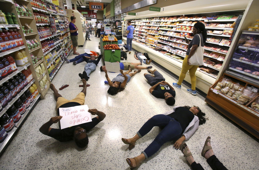 Demonstrators lay on the floor during a protest against gun violence at a Publix supermarket near downtown Orlando, Fla., on May 25.