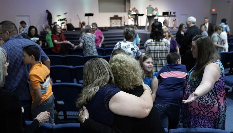 Dayspring Church members exchange hugs during service Sunday in Santa Fe, Texas. A gunman opened fire inside Santa Fe High School on Friday, killing at least 10 people. (AP Photo/David J.