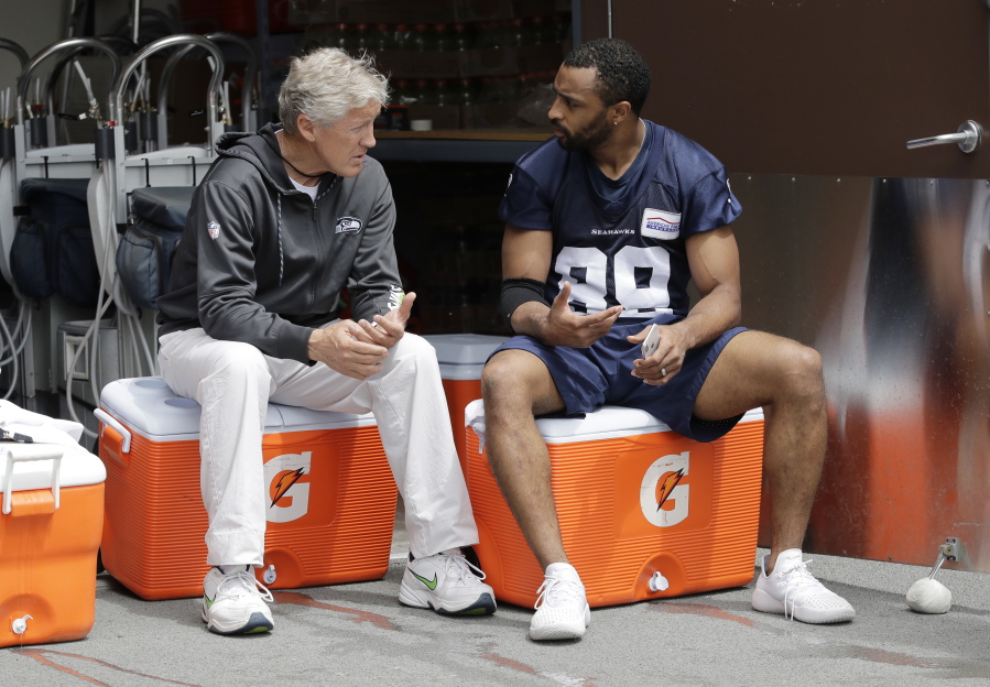 Seattle Seahawks wide receiver Doug Baldwin, right, talks with head coach Pete Carroll, left, following NFL football practice, Thursday, May 24, 2018, in Renton, Wash. (AP Photo/Ted S.