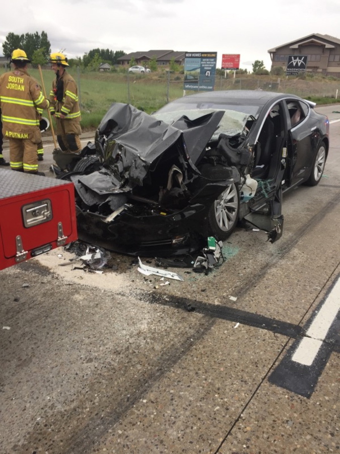A traffic collision involving a Tesla Model S sedan with a Fire Department mechanic truck stopped at a red light in South Jordan, Utah. The driver of a Tesla electric car that hit a Utah fire department vehicle over the weekend says the car’s semi-autonomous Autopilot mode was engaged at the time of the crash. Police in the Salt Lake City suburb of South Jordan said Monday, May 14, 2018, the driver also said in an interview that she was looking at her phone before the accident. The 28-year-old woman broke her foot when her car hit a fire truck stopped at a red light while going 60 mph (97 kph).