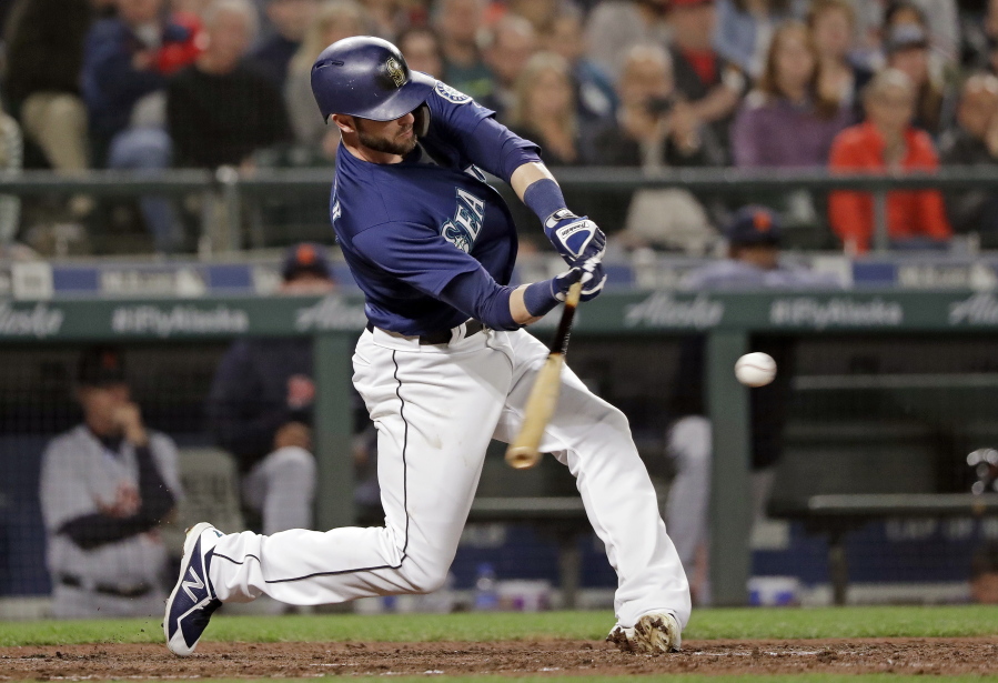 Seattle Mariners' Mitch Haniger doubles in a run against the Detroit Tigers during the seventh inning of a baseball game Friday, May 18, 2018, in Seattle.