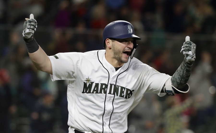 Seattle Mariners Mike Zunino celebrates after he hit a walk-off solo home run against the Minnesota Twins during the 12th inning of a baseball game, Saturday, May 26, 2018, in Seattle. The Mariners won 4-3. (AP Photo/Ted S.