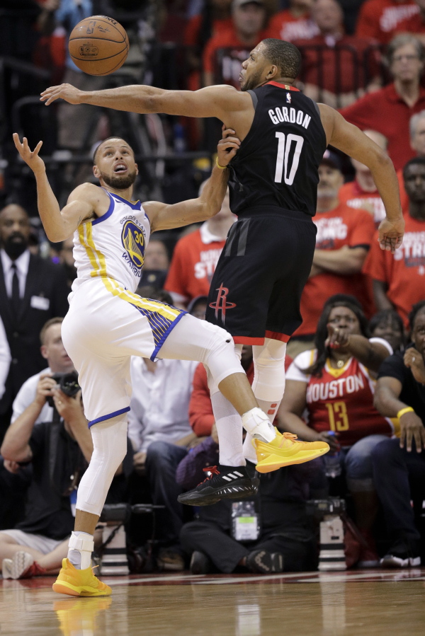 Houston Rockets guard Eric Gordon, right, blocks a shot by Golden State Warriors guard Stephen Curry during the second half in Game 5 of the NBA basketball playoffs Western Conference finals in Houston, Thursday, May 24, 2018. (AP Photo/David J.