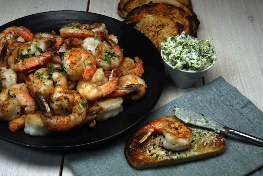 Shrimp are dusted with cornstarch before a quick spin in a hot skillet. The crispy crustaceans partner with a mint-chile butter.