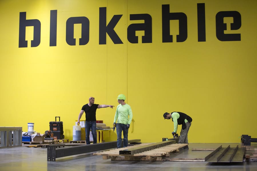 Workers assemble components at Blokable’s production facilities during a recent visit from Gov. Jay Inslee. The Seattle company makes its modular housing units — called bloks — in Vancouver.