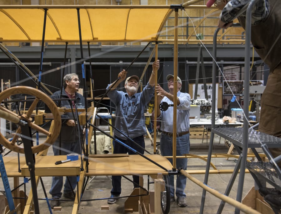 National Park Service volunteers work on a full-scale replica of the Curtiss Pusher that flew from Portland to Pearson Field in 1912. It will go on display Saturday at Pearson Air Museum.