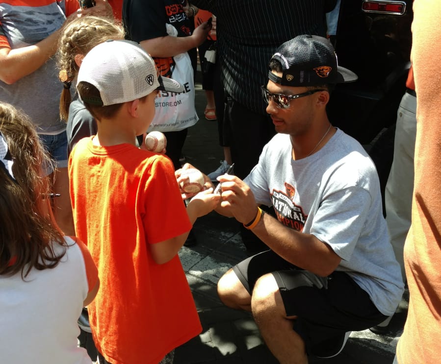 Oregon State’s Preston Jones signs autographs Friday in Portland, where a rally was held to celebrate the Beavers’ third national baseball title. Jones, a sophomore outfielder from Vancouver, appeared in six of the Beavers’ eight games at the College World Series in Omaha, Neb., including Thursday’s title-clinching win over Arkansas.