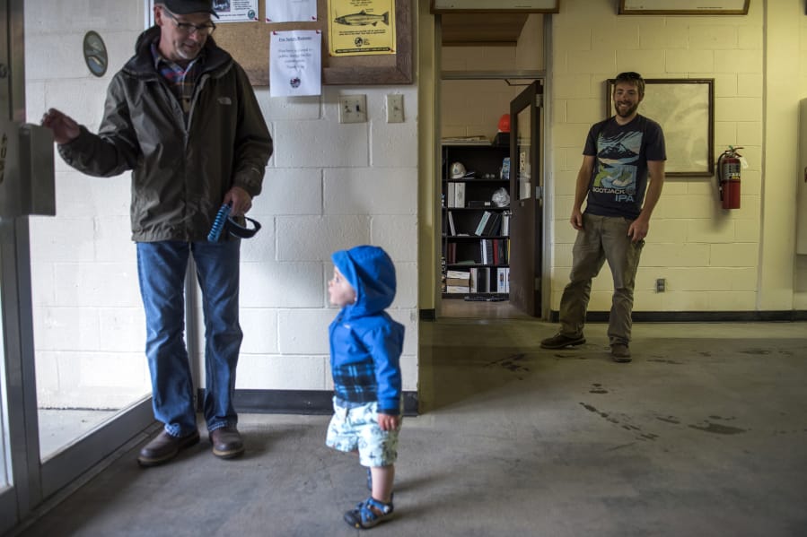 “It’s fun to see their relationship blossom,” says Andrew Brown, right. His father Rick Brown, left, and son Tabor often come to visit Andrew’s office at Kalama Falls Fish Hatchery when Rick is baby-sitting.