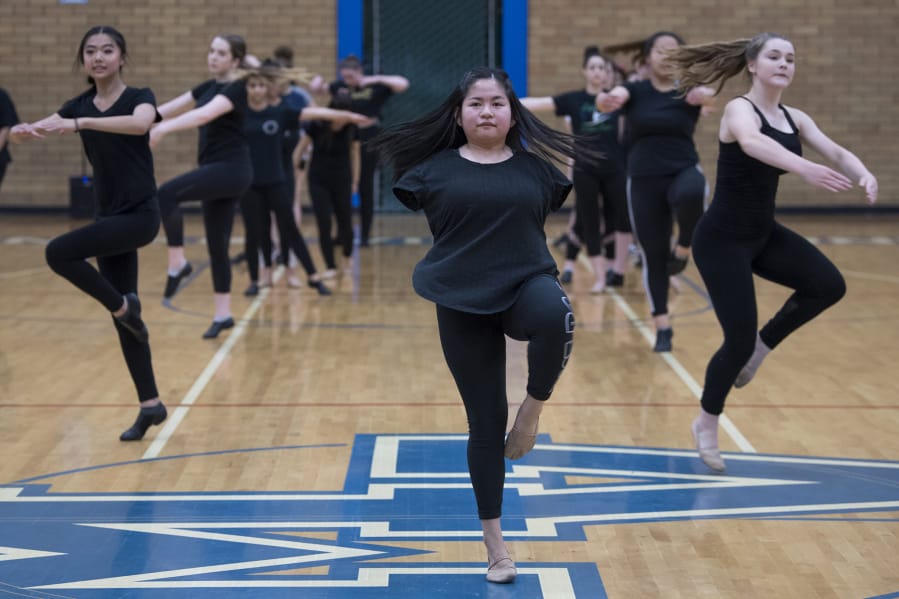 Mountain View High School senior Teresa Buchholz demonstrates across the floor exercises to the younger dancers during dance team tryouts at the high school on May 23.