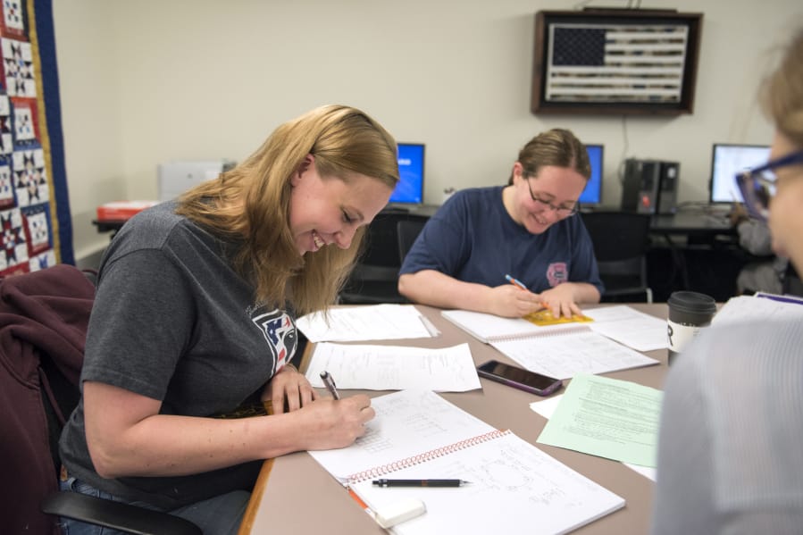 Alison Warlitner, from left, studies with friends Ashley Hopkins and Terri Vanderweide at the Clark College Veterans Resource Center on June 5. Warlitner is a Navy veteran and reservist who says she appreciates how the center supports her and her classmates.