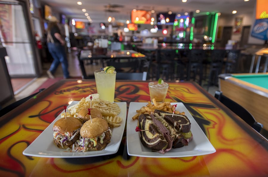 Barbecue pork sliders, clockwise from left, with a tequila punch cocktail, a green tea cocktail and a pastrami sandwich at the Offramp Sports Bar & Grill.