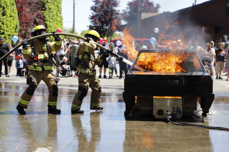 Firefighters demonstrate extinguishing a car fire at the Clark County Fire District 6 open house.