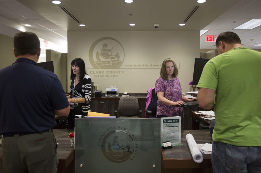 Jodi Creamer, left, and Trina Siebart are the front-line staff at the Clark County Permit Center, which county officials are currently seeking to overhaul.