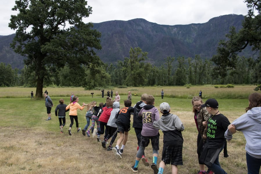 Canyon Creek Middle School students play a game of fire tag at Doetsch Day Use Area in Beacon Rock State Park on Thursday. The game simulates how wildfires grow and spread.