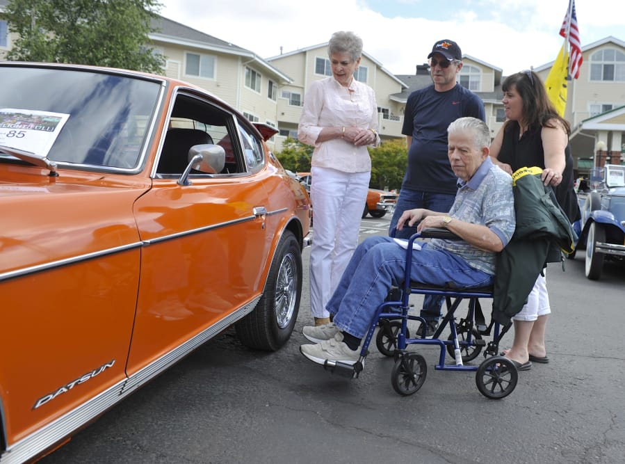 Touchmark at Fairway Village resident Layne Brannan, center, was surprised Saturday when his son-in-law Greg Sleeper showed up at the retirement community’s car show with his old whip, a Datsun 240Z. His wife Sharon Brannan, left, and daughter Brooke Sleeper, right, have fond memories of driving around in the two-seat coupe.